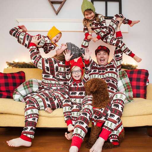 family in pajamas on the couch