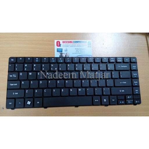 a keyboard on a desk with a credit card in the background.