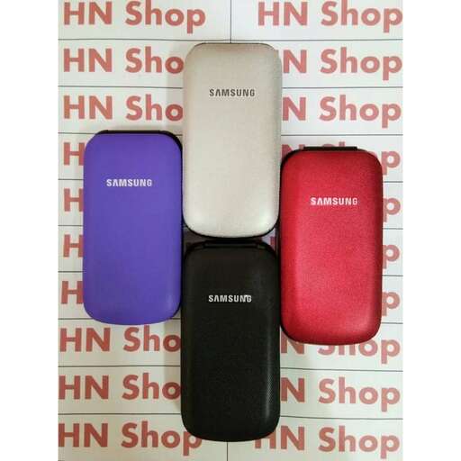 three cell phones are lined up on a table.