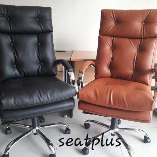 a pair of leather chairs with leather seats.