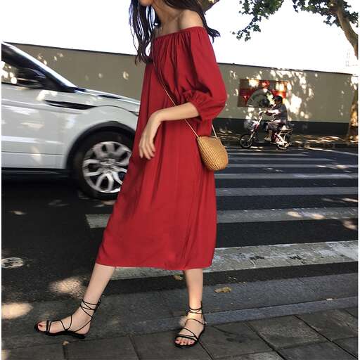 a red dress is worn by a woman