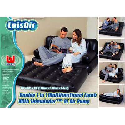 a couple sitting on a couch in a living room.