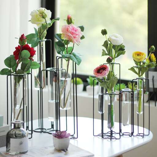a table with three vases of flowers on it.