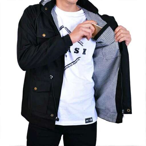 a man holding a jacket in his hands.