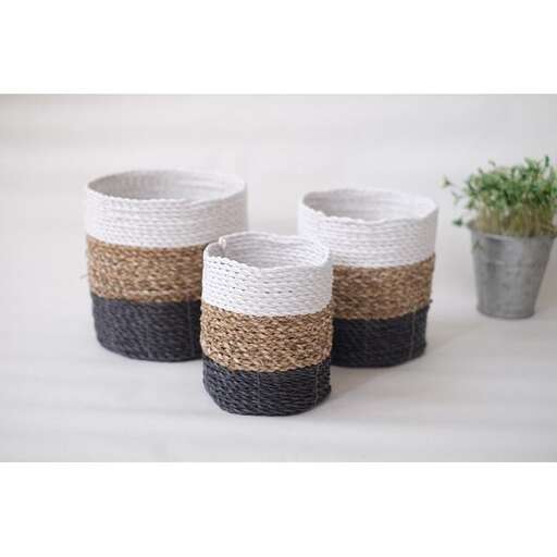 a set of wicker baskets with a plant in the middle.