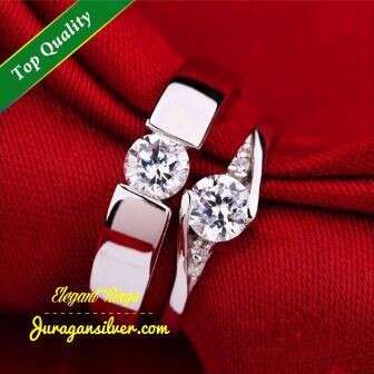 a watch with a diamond on it and a red shirt.