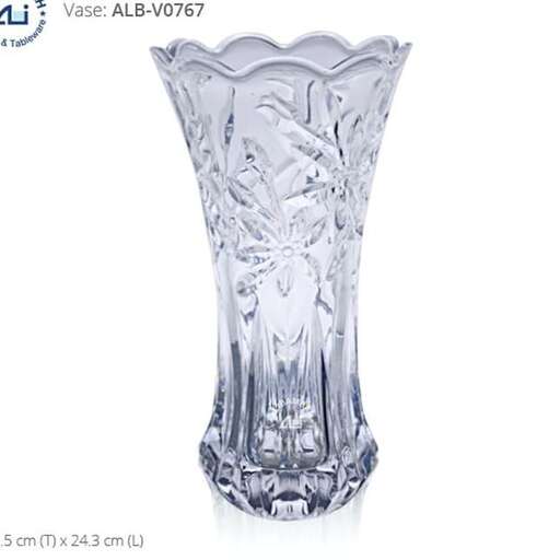 a tall glass vase with a design of a tree on the top.