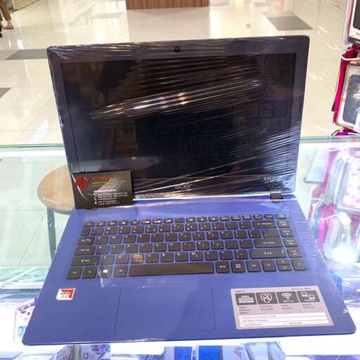 a laptop computer sitting on top of a glass case.