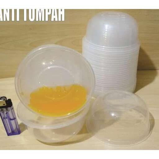 a cup of orange juice next to a cup of water.
