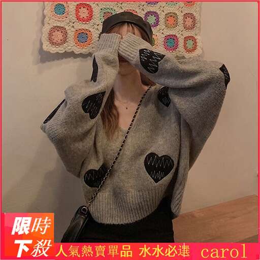 the sweater is a sweater with a black heart pattern.