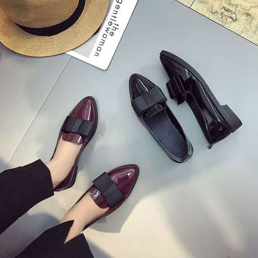 a woman's shoes and a hat are on a table.
