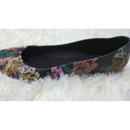 a pair of shoes with floral print on the sole