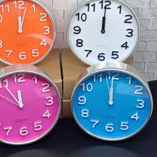 four different colored clocks with different colored faces.