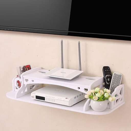a white shelf with a computer and a bunch of flowers
