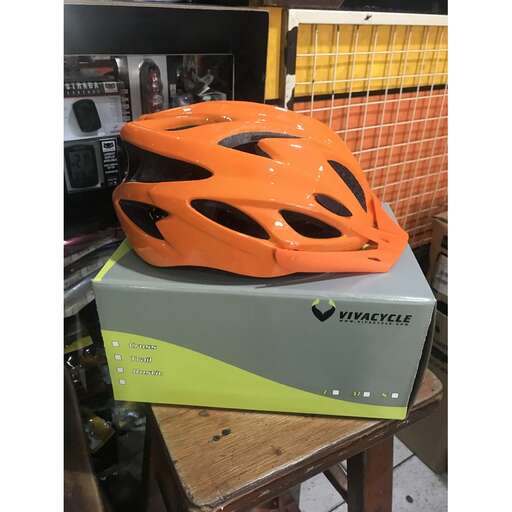 a helmet on a table with a box of tape.