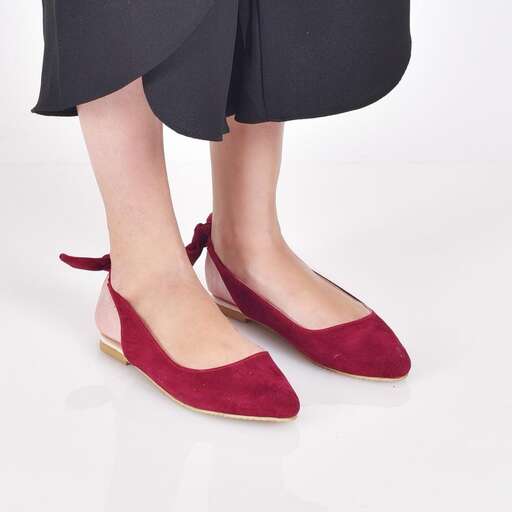a woman's red flat shoes with a black skirt and a black skirt