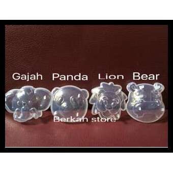 a set of three glass beads with a bear in the middle.