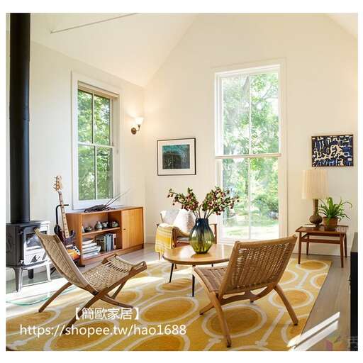 a living room with a table, chairs and a fireplace.
