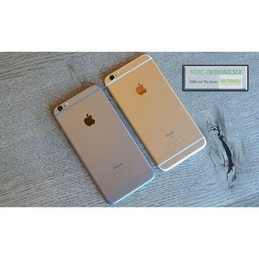 a gold iphone with a black wire attached to it.