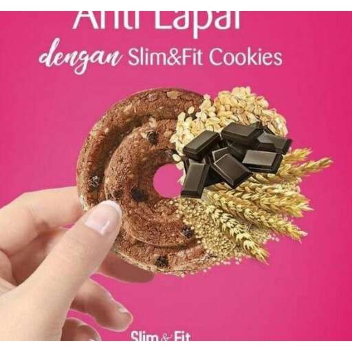 a woman is holding a chocolate covered doughnut.