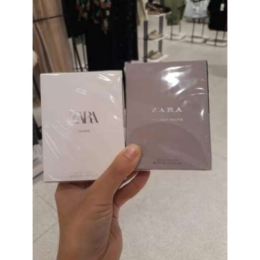 a hand holding a new bag in a store