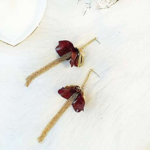 a pair of dried flowers on a white wood table.
