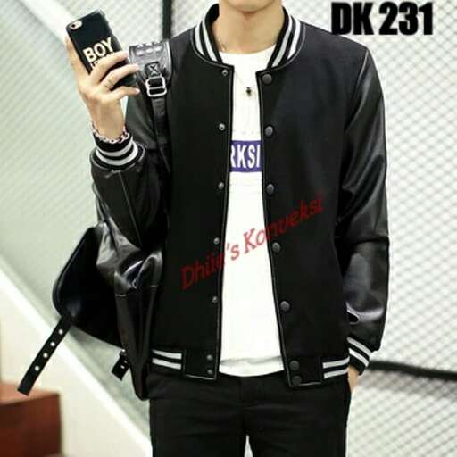 a man in a black jacket holding a camera