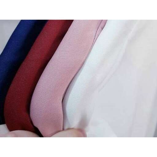 a close up of a person holding a white shirt and red ties.