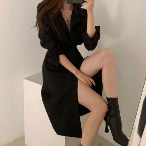a model in a black dress and high heeled boots