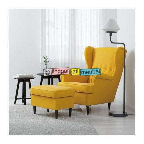 a yellow chair with a lamp and a lamp