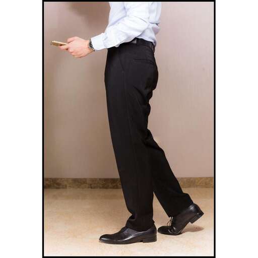 a man in a dress shirt and black pants.