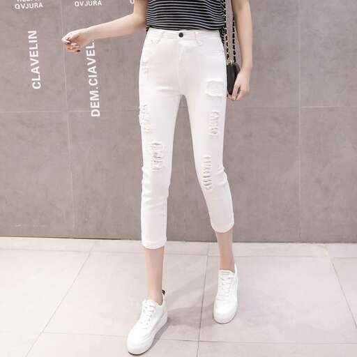 a model in white jeans and a striped t - shirt.