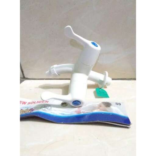 a toothbrush is sitting on a tile floor.