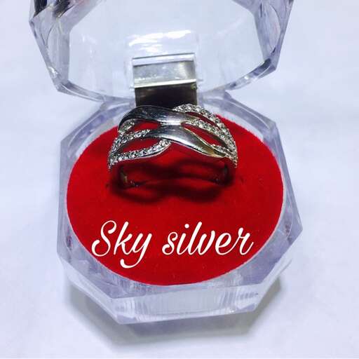 silver ring with silver metal clasp in a glass bottle