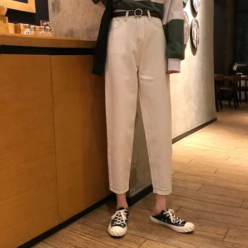 a man standing in front of a counter with a jacket on.
