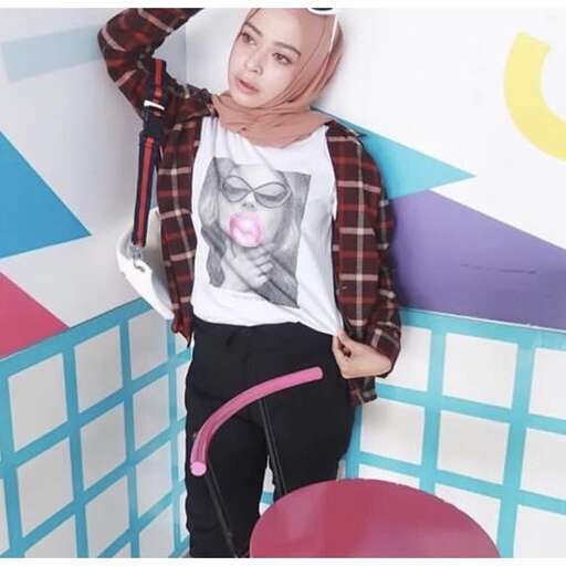 person poses in a t - shirt and pants.