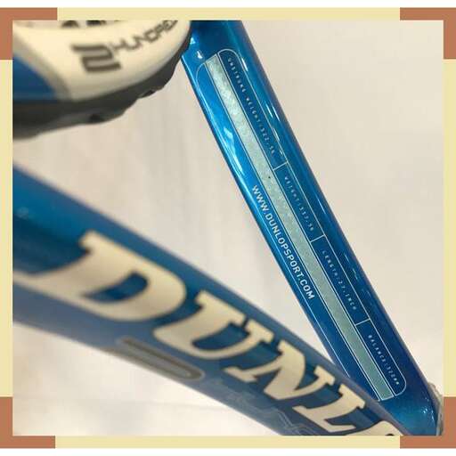 a blue and white baseball bat sitting on top of a white surface.