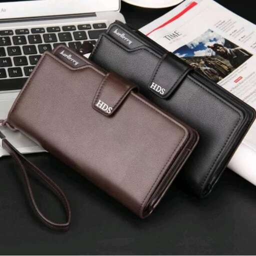 a brown leather wallet sitting next to a laptop computer.