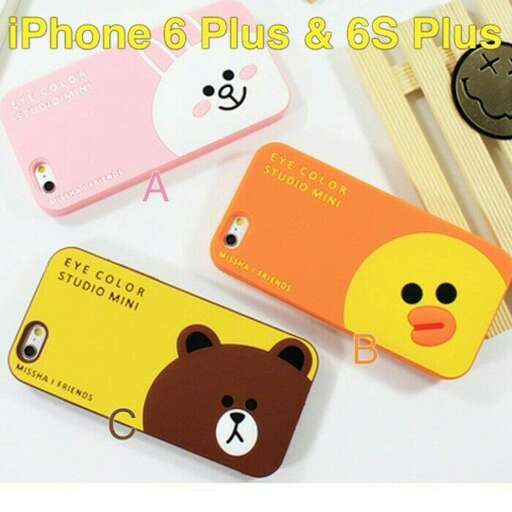 a cell phone and a toy with a bear on it.