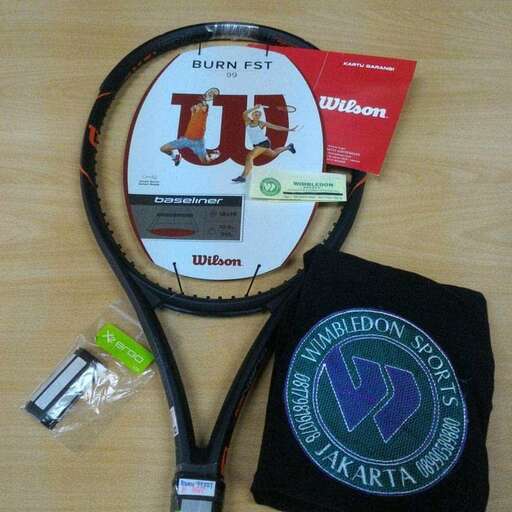 a tennis racket and a bag on a table.