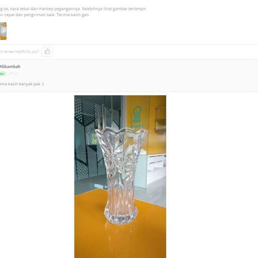 a glass vase sitting on top of a table.
