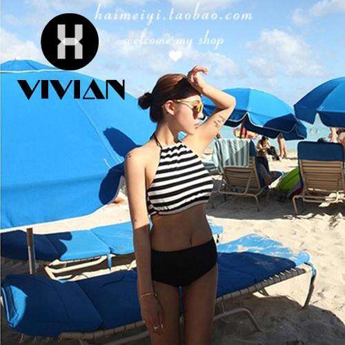 a woman standing on a beach with a hat on