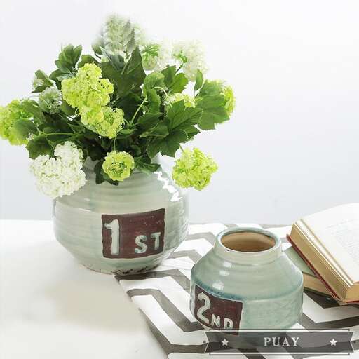 a vase with flowers and a book on a table.