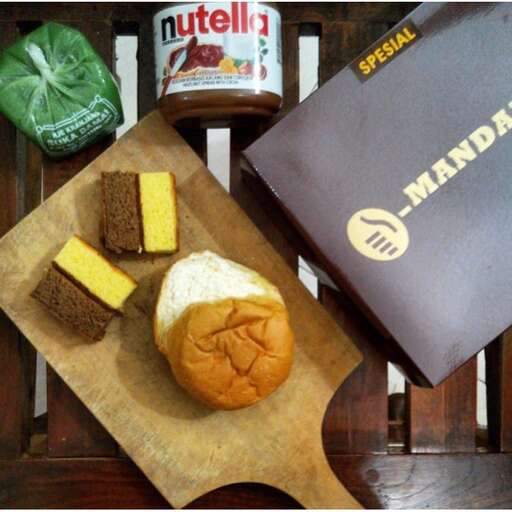 a sandwich and a box of food on a table.