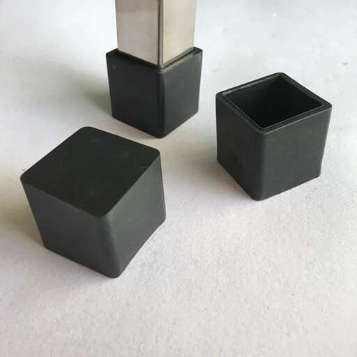 a group of three black boxes sitting on top of a white surface.