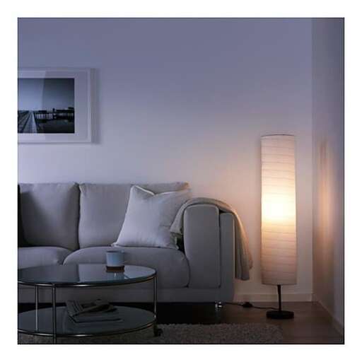 a living room with a couch, table, and lamp.