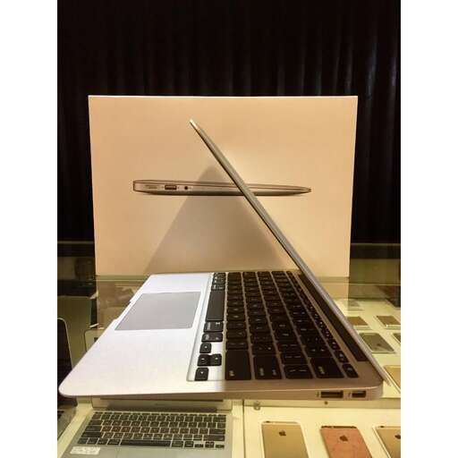 a laptop computer sitting on top of a glass table.