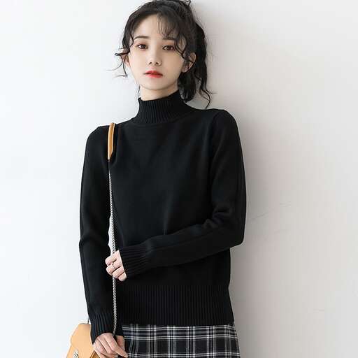 person is wearing a black turtleneck sweater with a pleated skirt and a pleated skirt