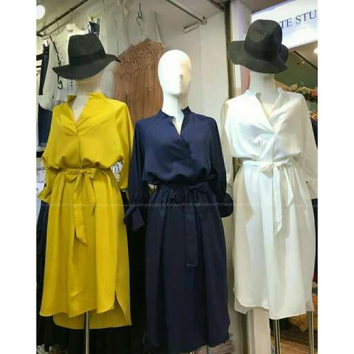 the dress and the hats are in the window of the store.