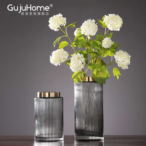 a silver vase with flowers in it